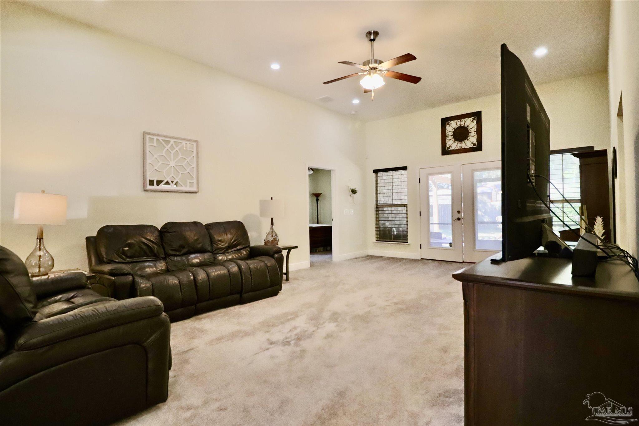 3934 Fielding Court Pace, FL 32571 - Photo 11 of 49 a living room with furniture and a flat screen tv