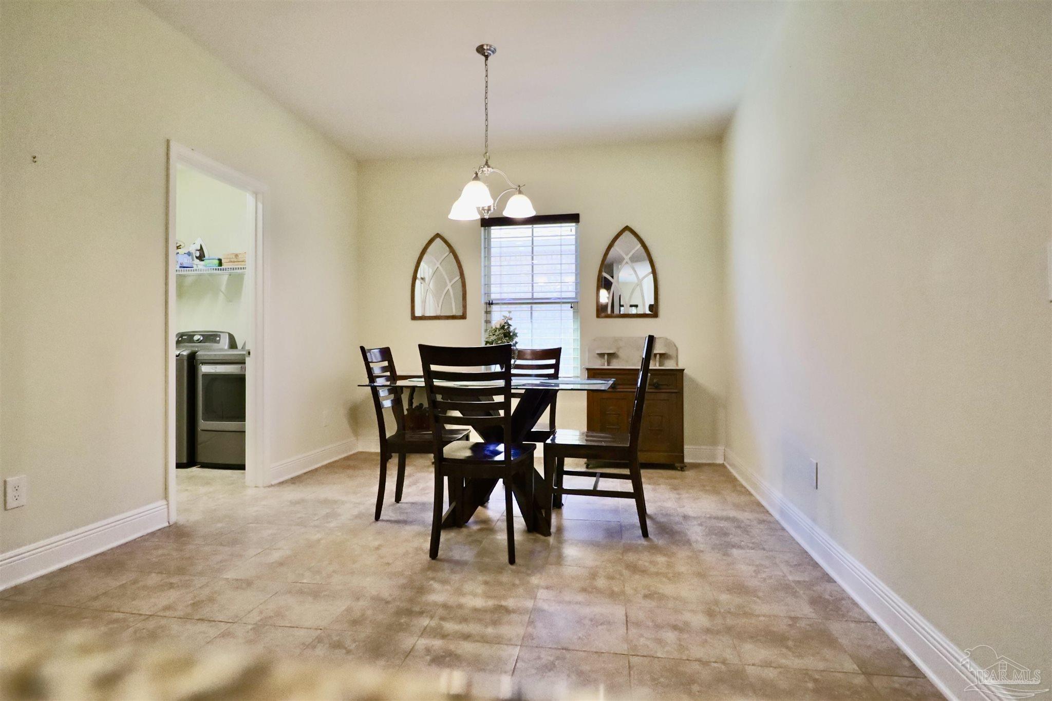 3934 Fielding Court Pace, FL 32571 - Photo 12 of 49 a view of a dining room with furniture and a chandelier