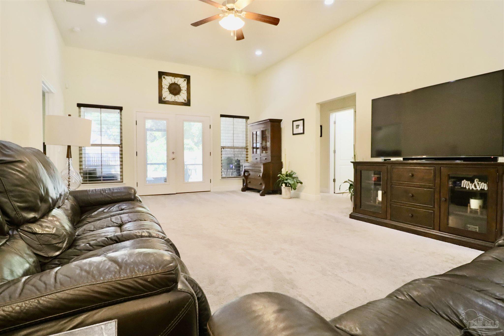 3934 Fielding Court Pace, FL 32571 - Photo 18 of 49 a spacious bedroom with a bed and a flat screen tv