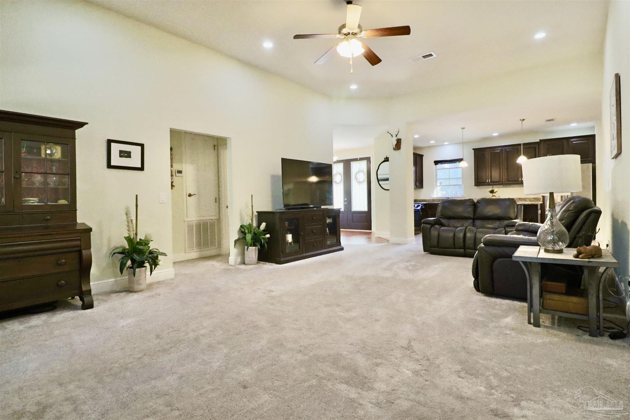 3934 Fielding Court Pace, FL 32571 - Photo 21 of 49 a living room with furniture and a flat screen tv
