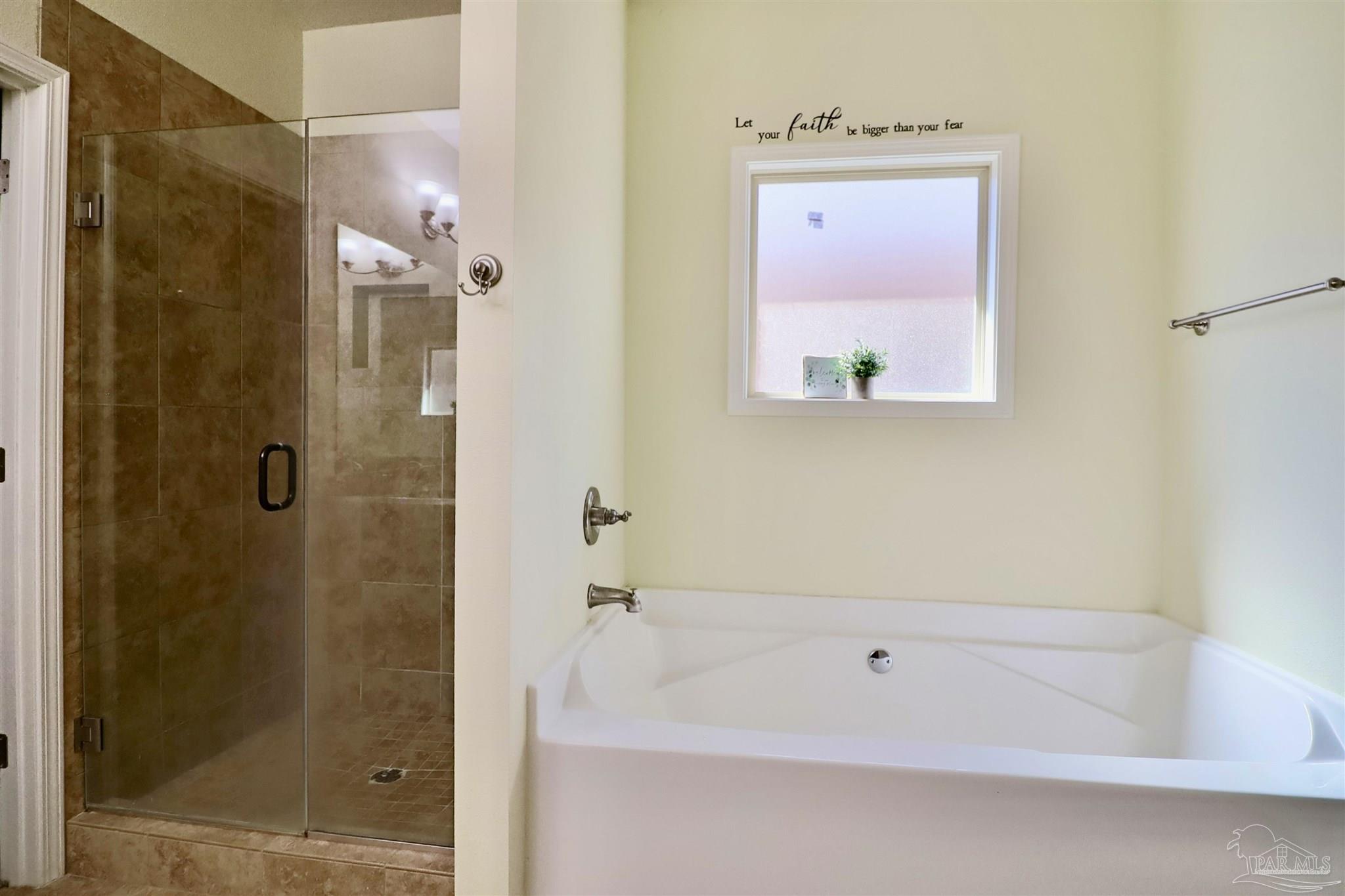 3934 Fielding Court Pace, FL 32571 - Photo 30 of 49 a bathroom with a bathtub shower and a sink