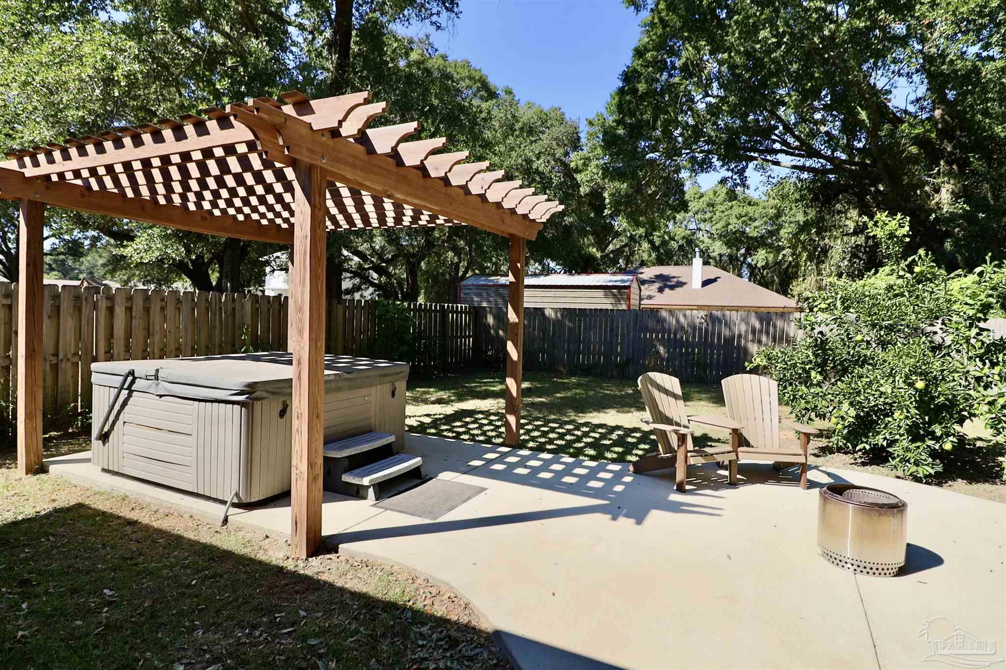 3934 Fielding Court Pace, FL 32571 - Photo 42 of 49 a view of a patio with table and chairs potted plants and large tree