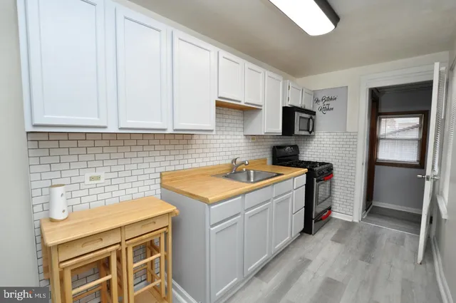 a kitchen with a stove and a refrigerator