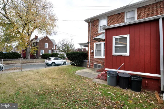 a view of a house with a yard and a tree