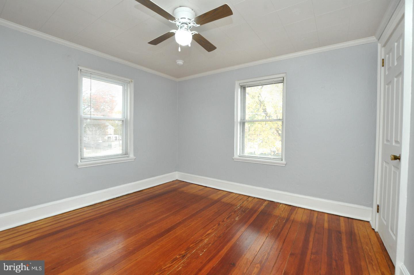3069 South Chesapeake Road Camden, NJ 08104 - Photo 7 of 30 a view of an empty room with wooden floor and a window