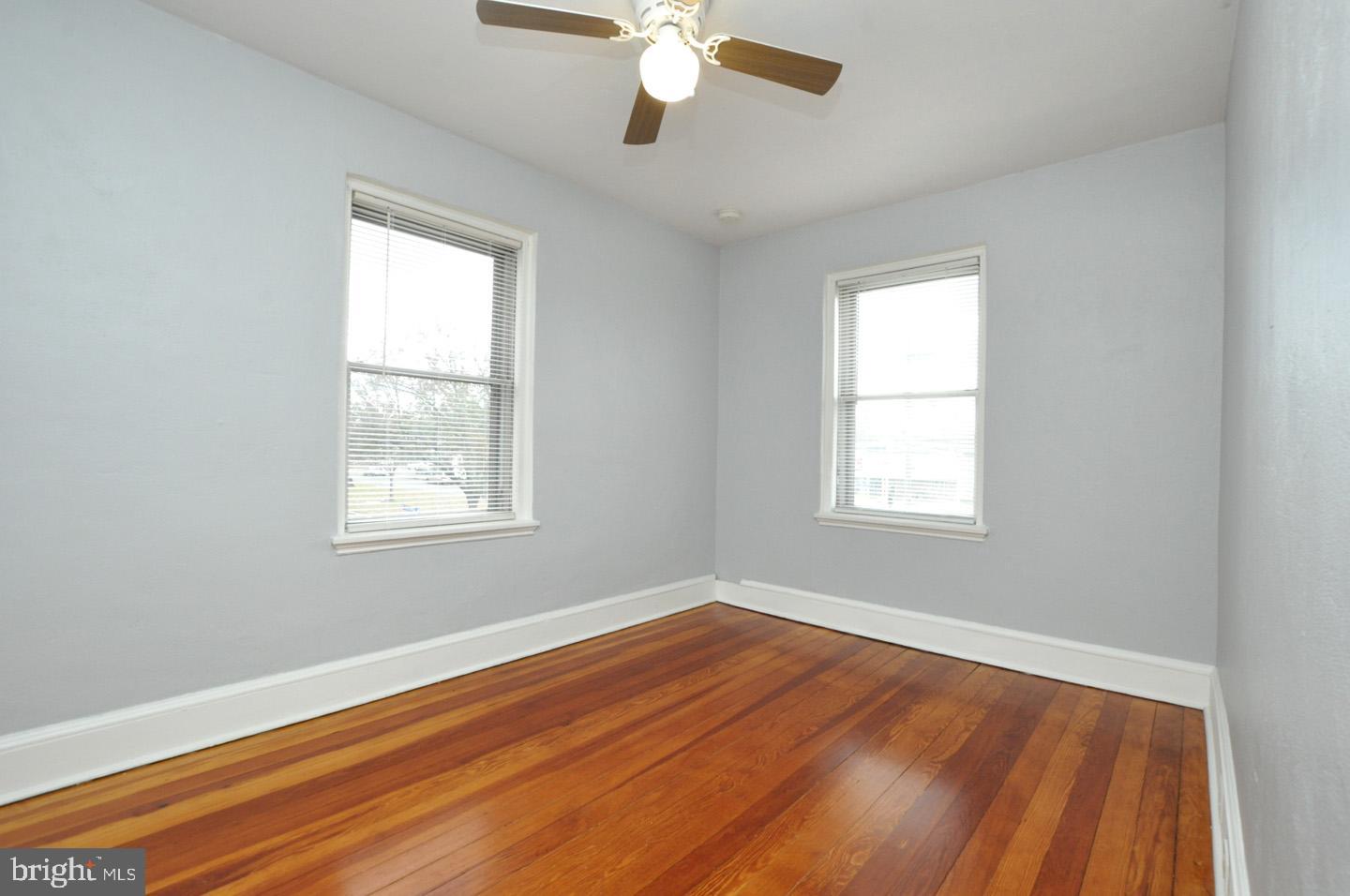 3069 South Chesapeake Road Camden, NJ 08104 - Photo 9 of 30 a view of an empty room with wooden floor and a window