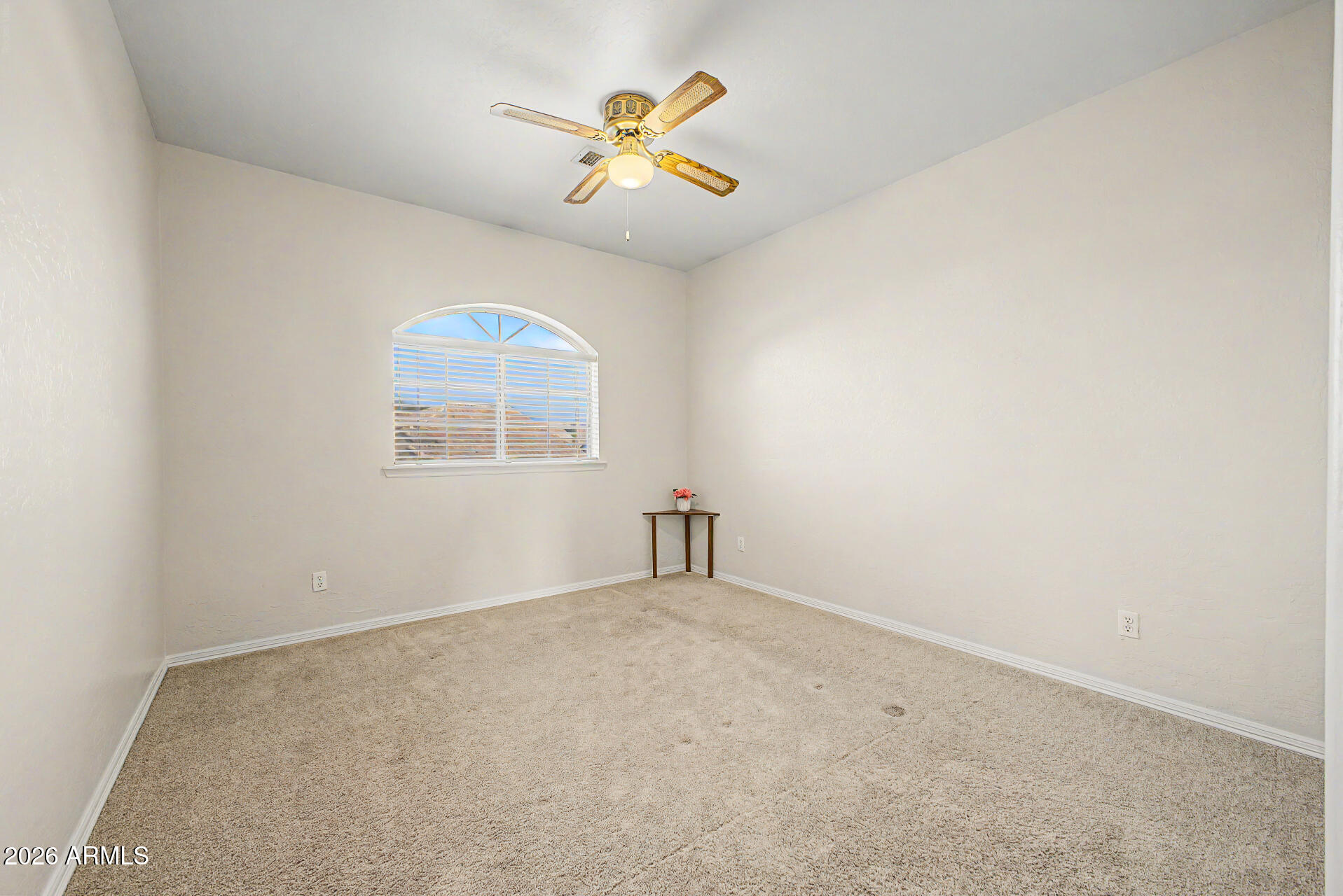 1124 North Robin Lane Mesa, AZ 85213 - Photo 16 of 87 an empty room with windows and chandelier fan