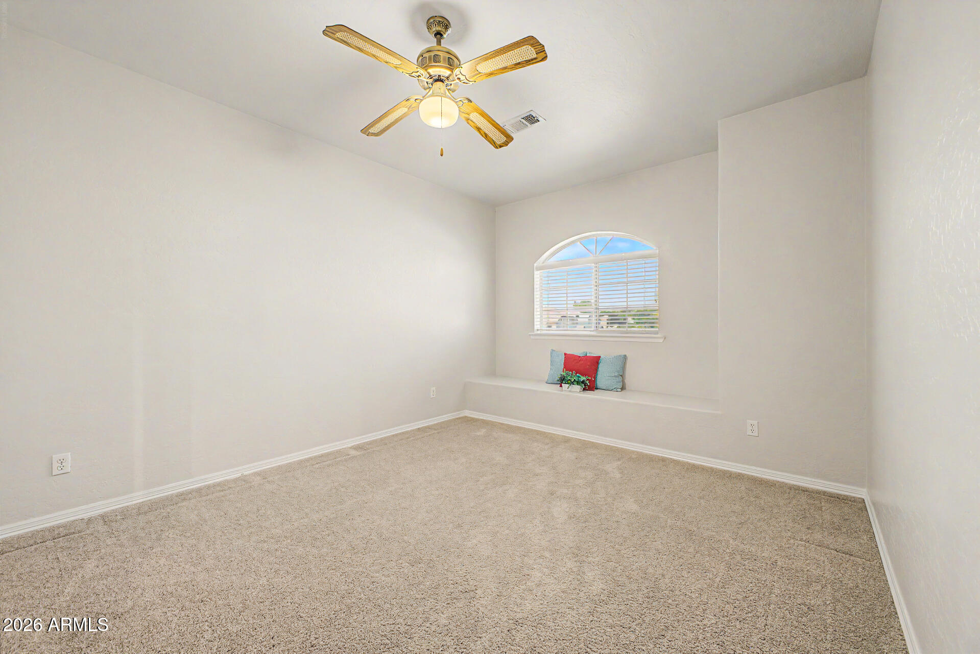 1124 North Robin Lane Mesa, AZ 85213 - Photo 17 of 87 an empty room with a window and a fan