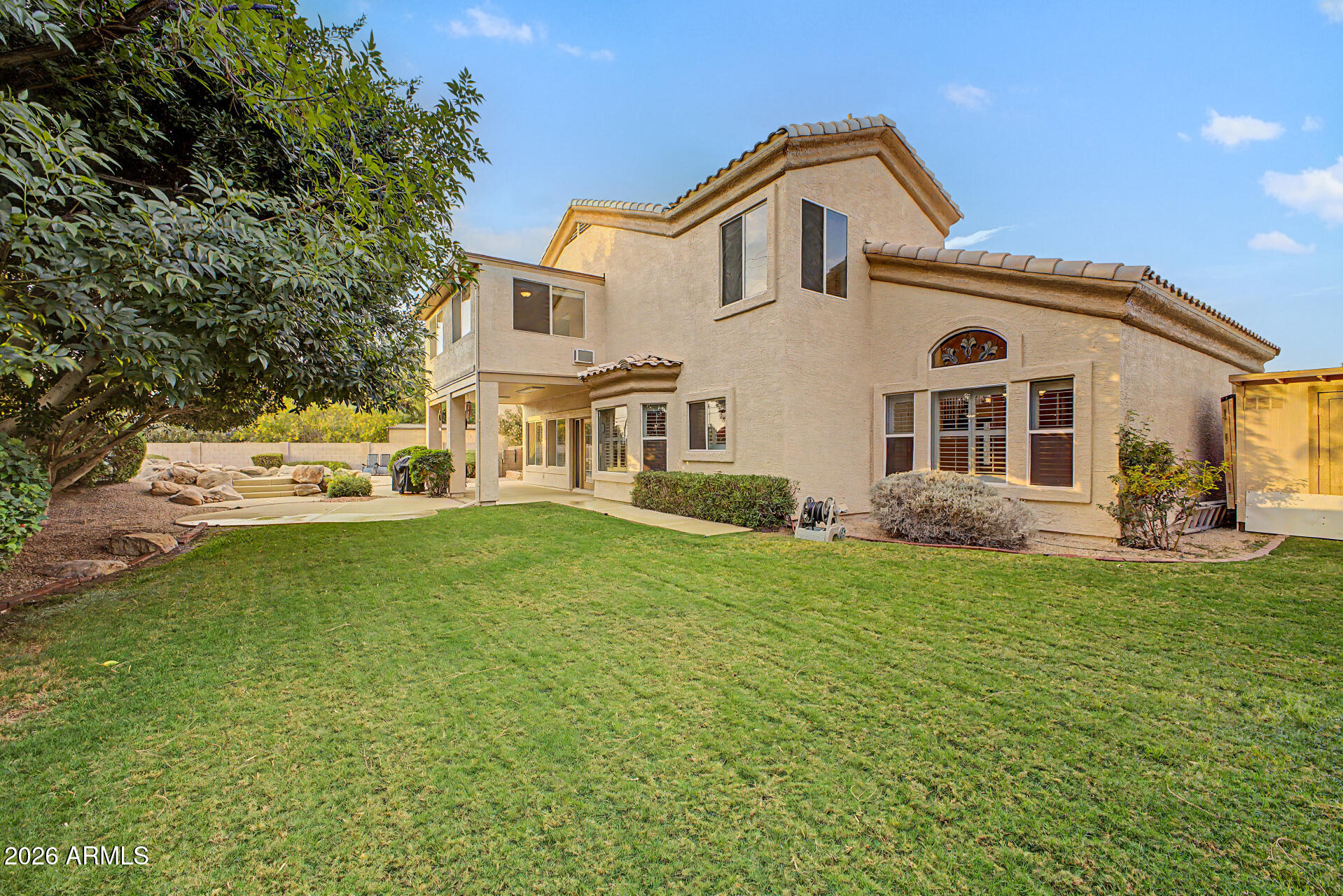 1124 North Robin Lane Mesa, AZ 85213 - Photo 29 of 87 a front view of a house with a garden