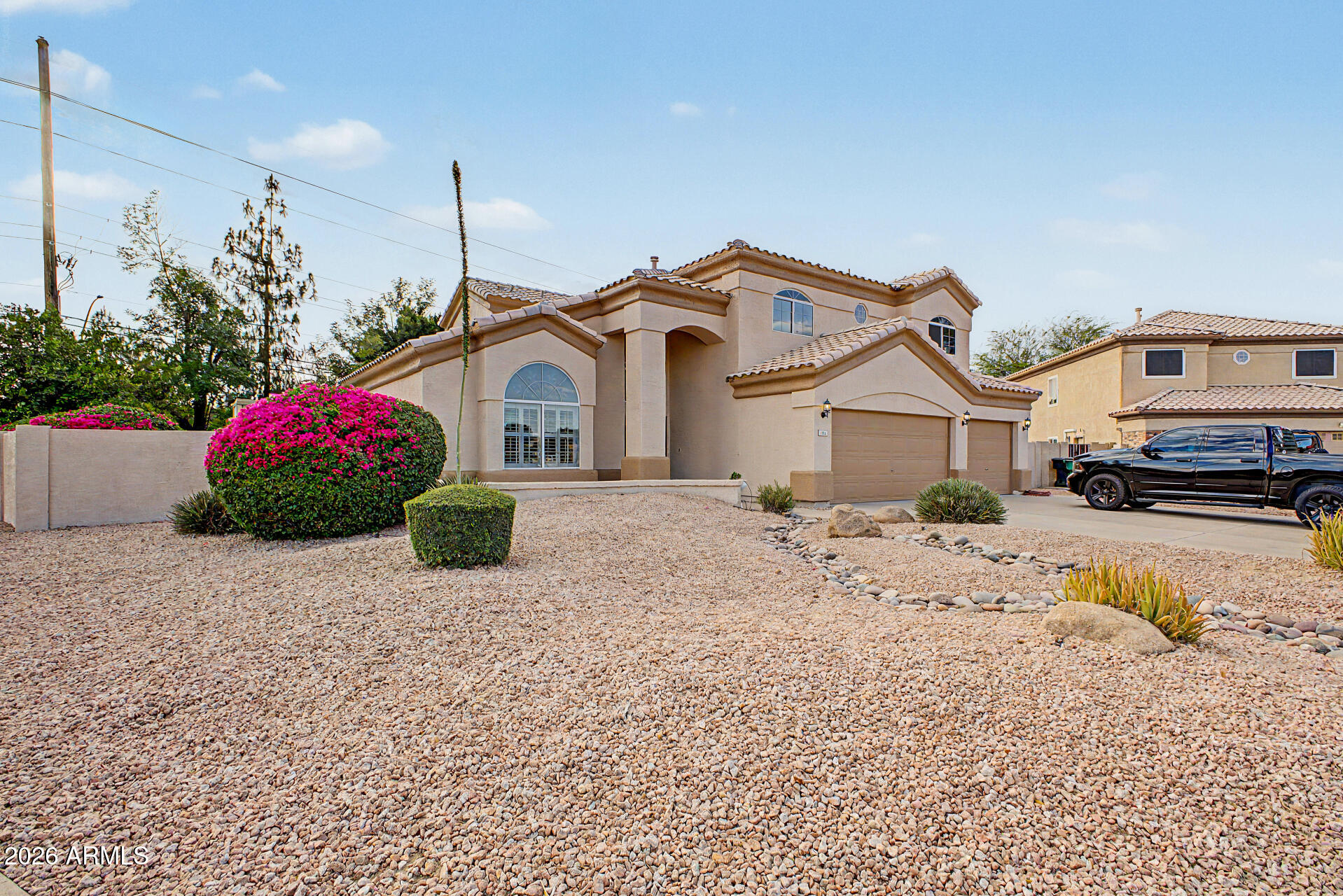 1124 North Robin Lane Mesa, AZ 85213 - Photo 40 of 87 a front view of a house with a yard