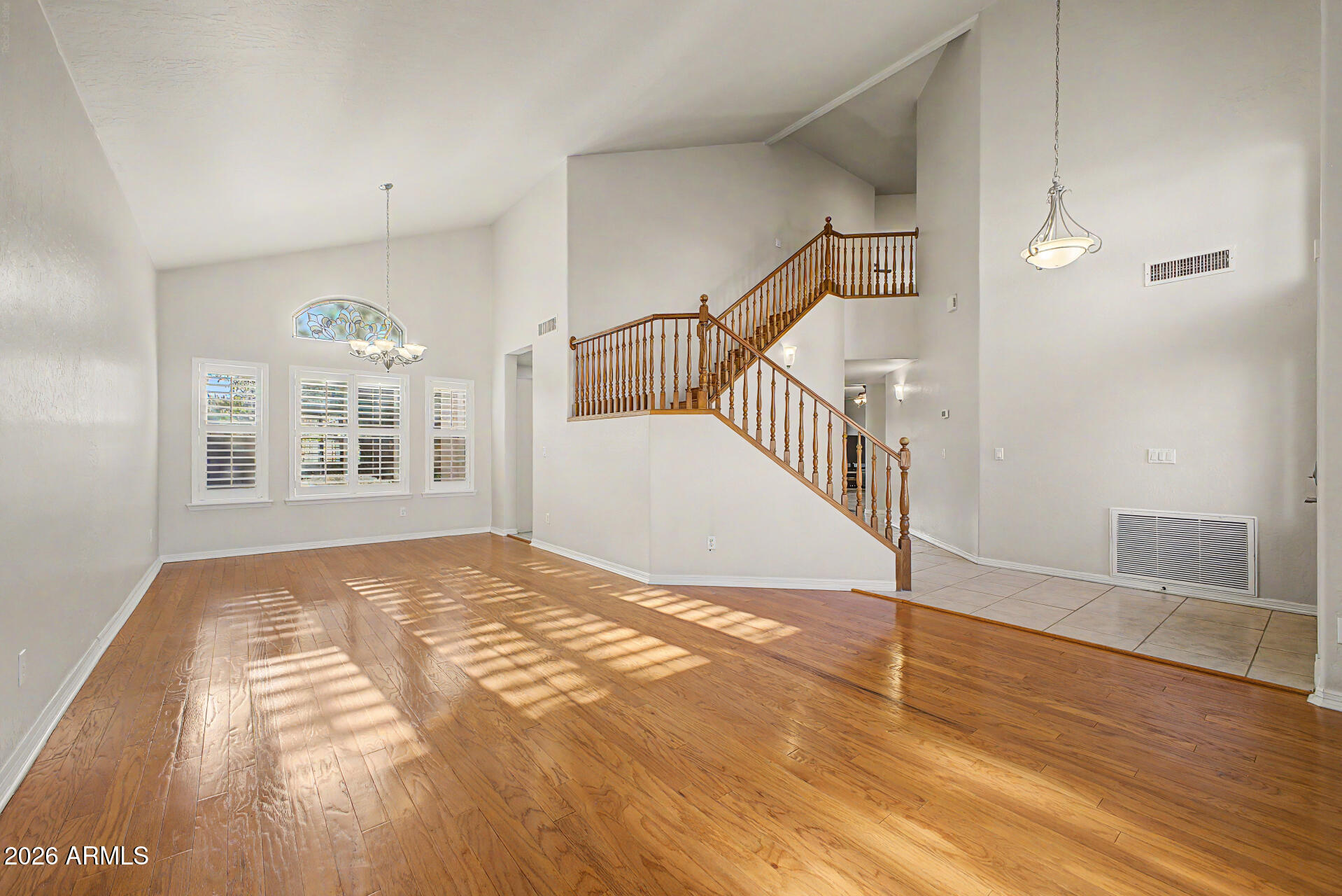 1124 North Robin Lane Mesa, AZ 85213 - Photo 5 of 87 a view of a livingroom with wooden floor and staircase