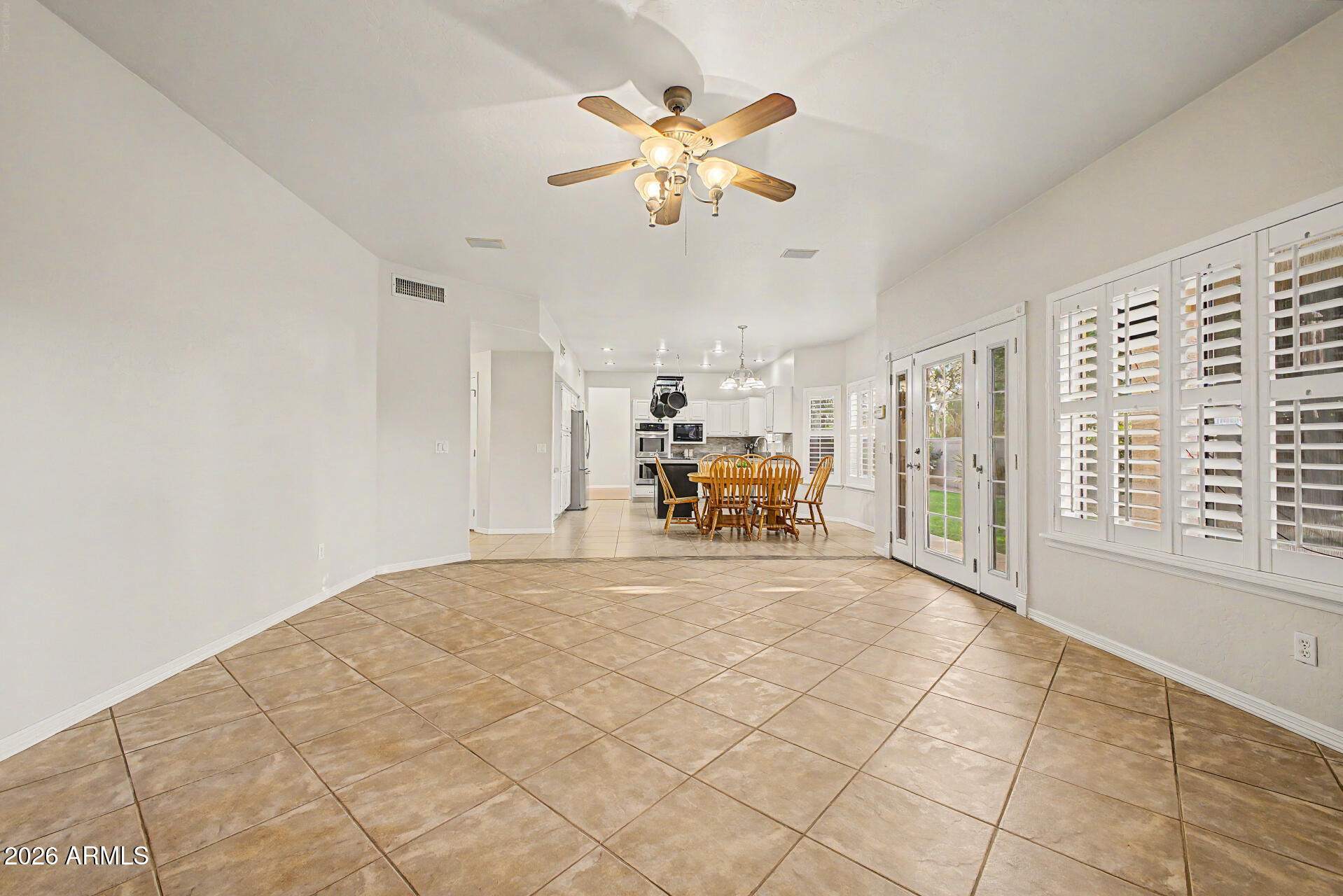 1124 North Robin Lane Mesa, AZ 85213 - Photo 54 of 87 a view of a livingroom with wooden floor and a ceiling fan