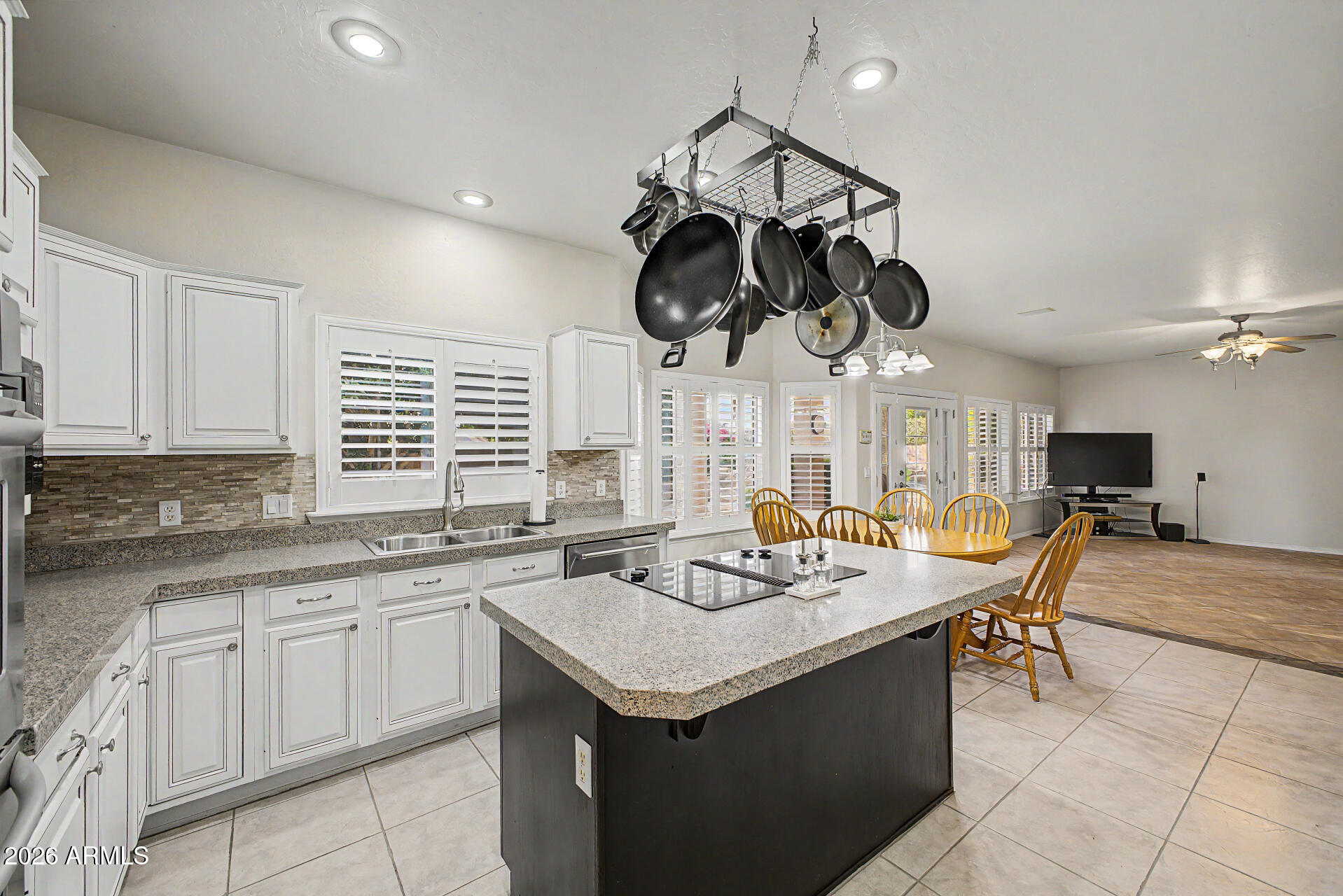 1124 North Robin Lane Mesa, AZ 85213 - Photo 58 of 87 a kitchen with a sink a stove and chairs