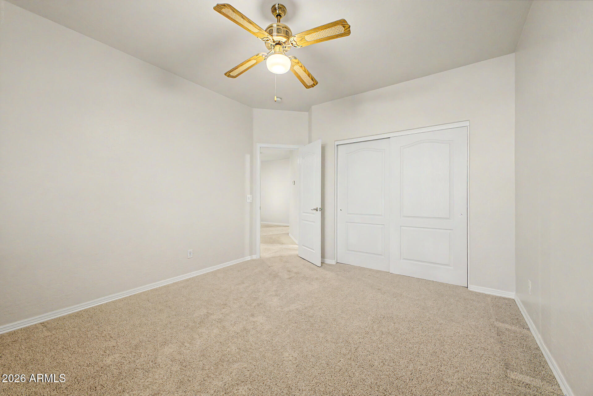 1124 North Robin Lane Mesa, AZ 85213 - Photo 73 of 87 an empty room with a ceiling fan and a window