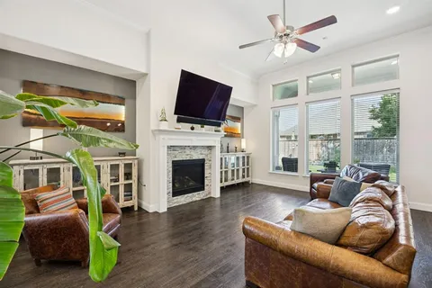 a living room with furniture a flat screen tv and a fireplace