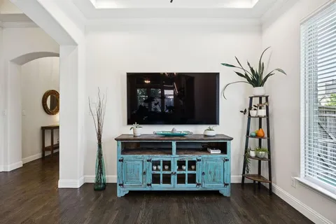 a kitchen with a stove and wooden floor