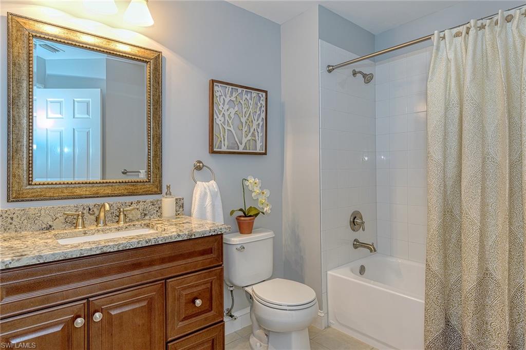 988 Hampton Circle Naples, FL 34105 - Photo 15 of 20 a bathroom with a sink a toilet and shower
