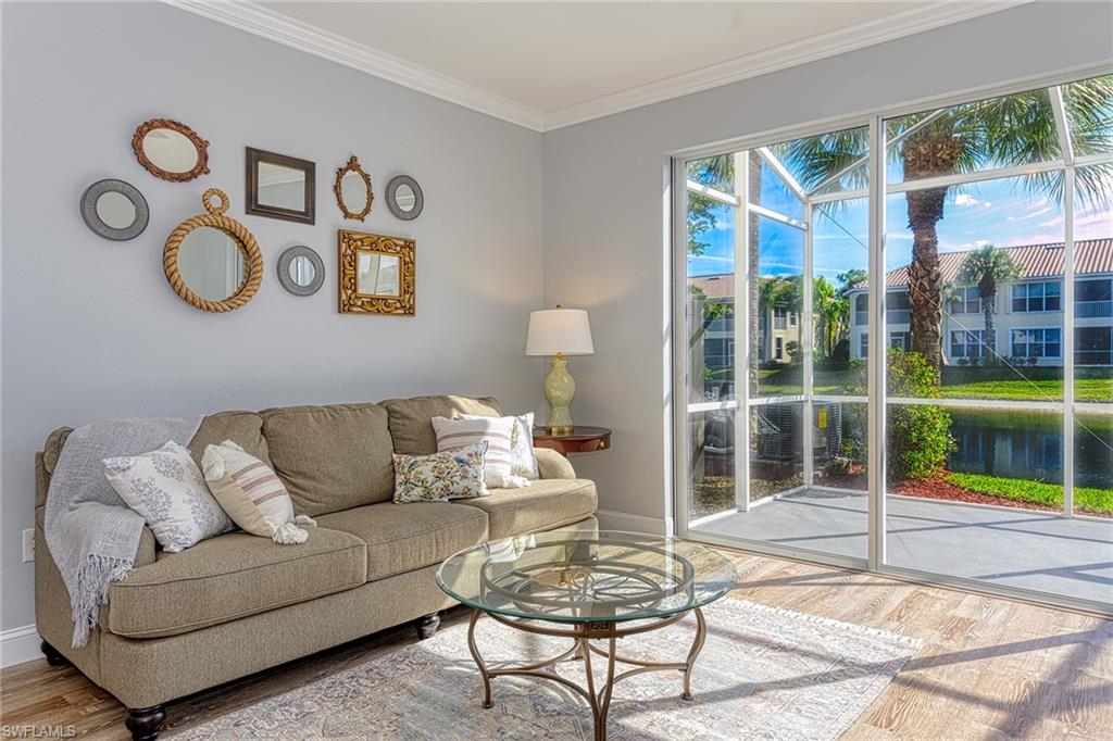 988 Hampton Circle Naples, FL 34105 - Photo 5 of 20 a living room with furniture and a floor to ceiling window