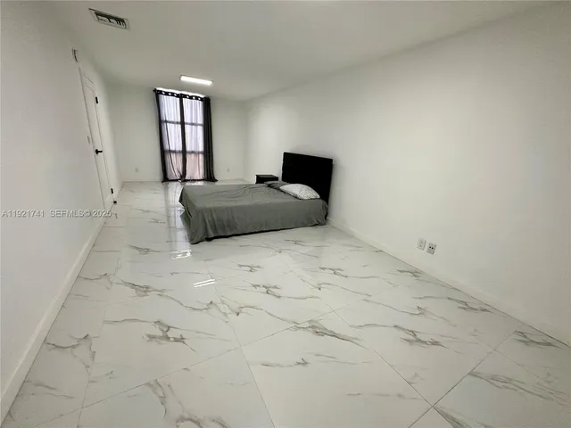 a bedroom with a bed and window