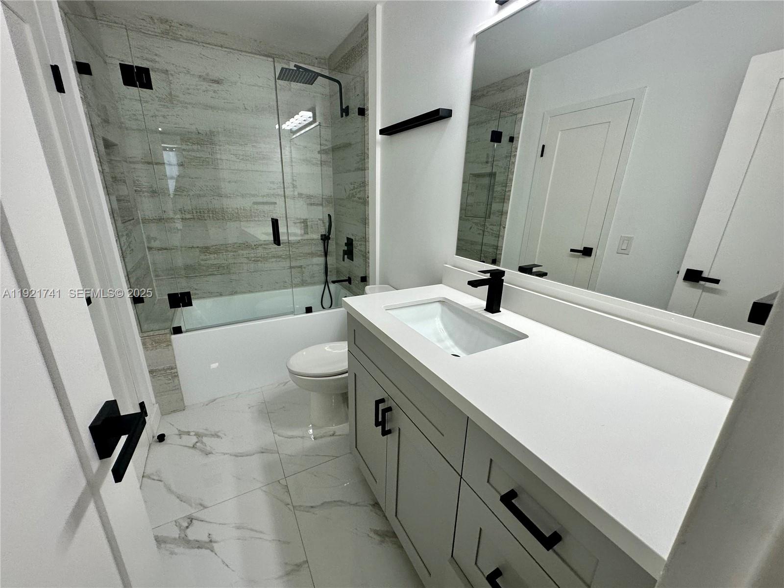13499 Biscayne Boulevard, Unit PH1709 North Miami, FL 33181 - Photo 10 of 11 a bathroom with a sink a toilet and shower