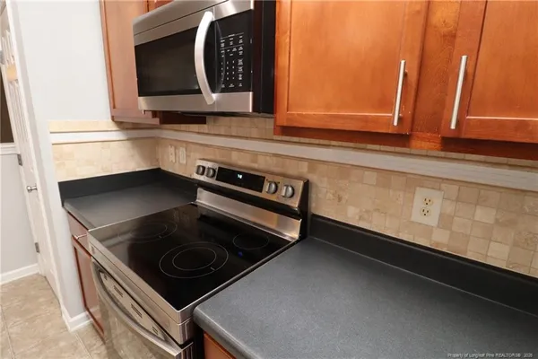 a kitchen with a stove and a microwave