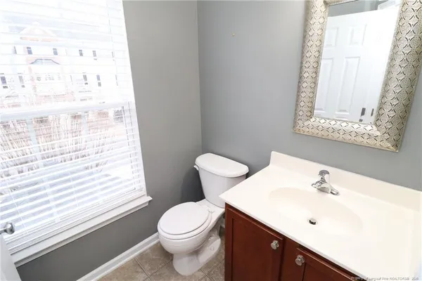 a bathroom with a sink a toilet and a window