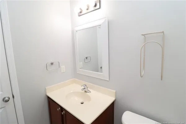 a bathroom with a sink a toilet and mirror