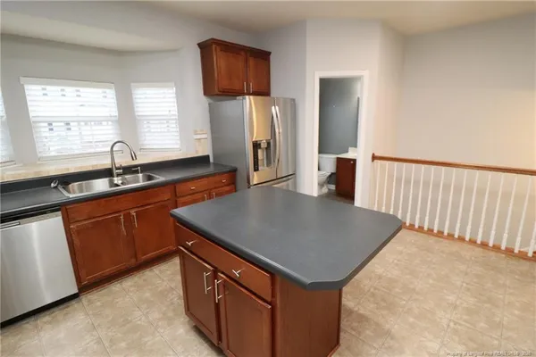 a kitchen with stainless steel appliances granite countertop a sink a microwave counter space and window