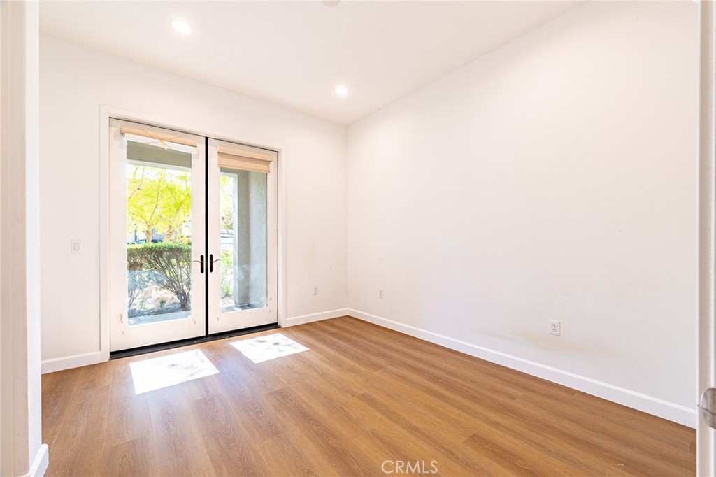 172 Follyhatch Irvine, CA 92618 - Photo 16 of 39 an empty room with wooden floor and windows