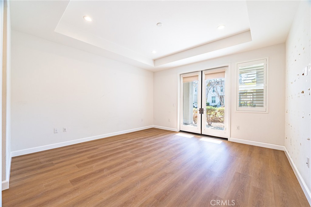172 Follyhatch Irvine, CA 92618 - Photo 18 of 39 an empty room with wooden floor and windows