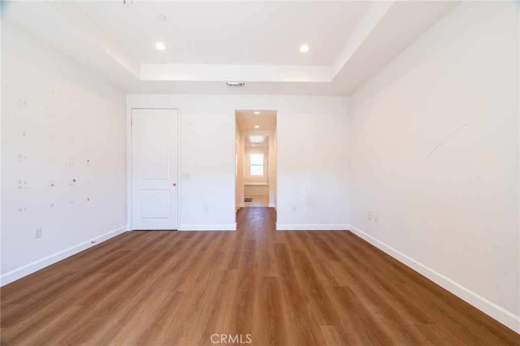 172 Follyhatch Irvine, CA 92618 - Photo 20 of 39 a view of empty room with wooden floor and fan