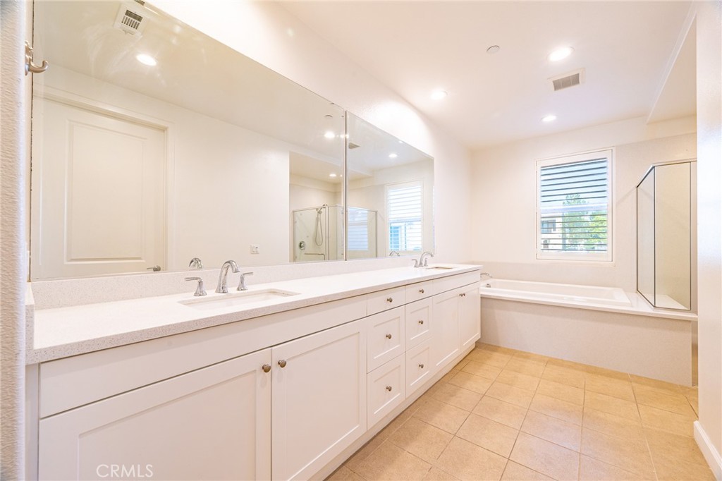 172 Follyhatch Irvine, CA 92618 - Photo 23 of 39 a bathroom with a granite countertop sink mirror and a