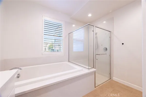 a spacious bathroom with a bathtub and a shower