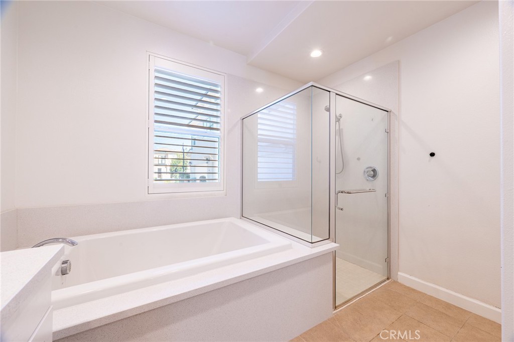 172 Follyhatch Irvine, CA 92618 - Photo 24 of 39 a spacious bathroom with a bathtub and a shower