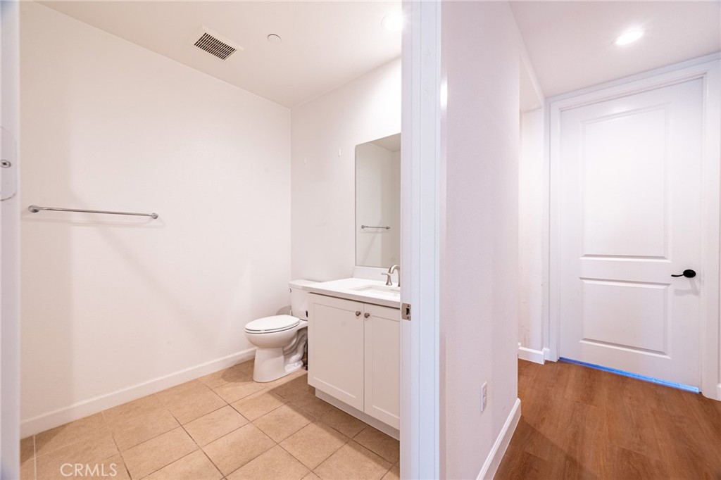 172 Follyhatch Irvine, CA 92618 - Photo 26 of 39 a bathroom with a granite countertop sink and a toilet