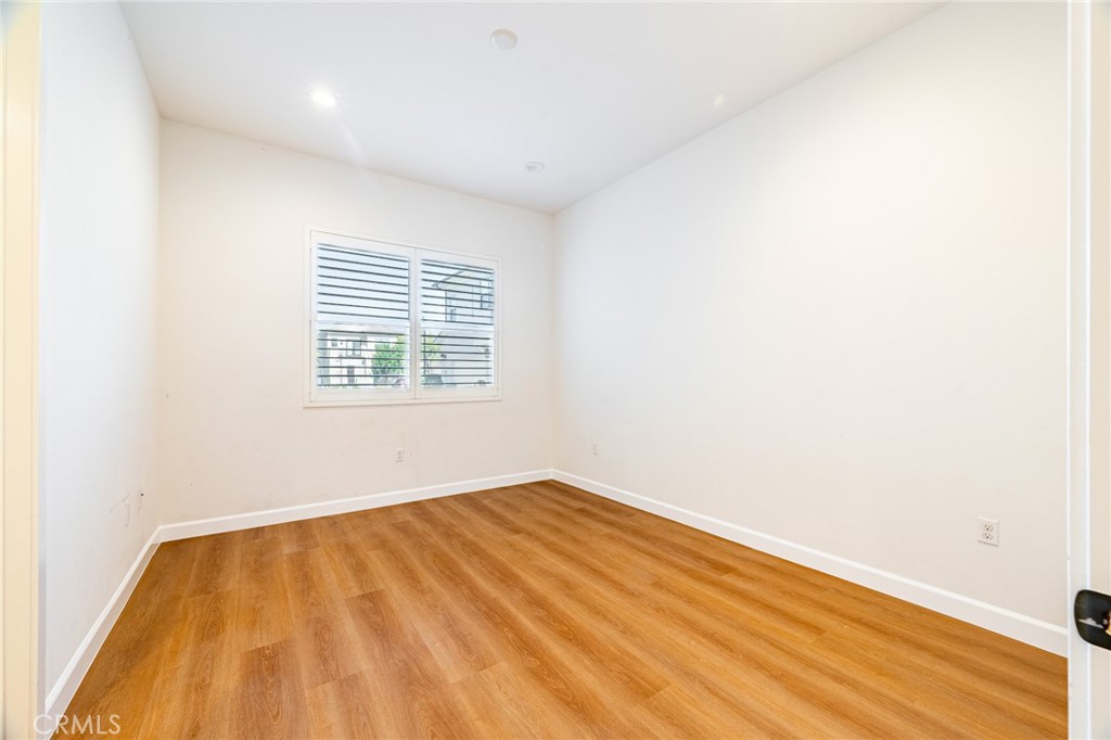 172 Follyhatch Irvine, CA 92618 - Photo 28 of 39 an empty room with wooden floor and windows