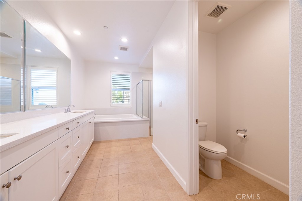172 Follyhatch Irvine, CA 92618 - Photo 3 of 39 a bathroom with a granite countertop toilet a sink and bathtub