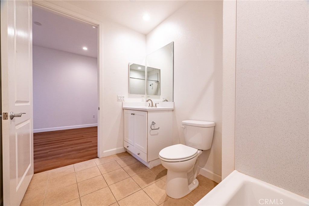 172 Follyhatch Irvine, CA 92618 - Photo 31 of 39 a bathroom with a toilet a sink and mirror