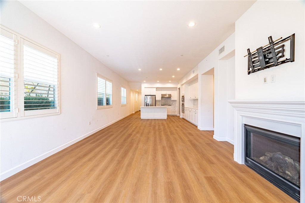 172 Follyhatch Irvine, CA 92618 - Photo 5 of 39 a view of empty room with wooden floor and fireplace