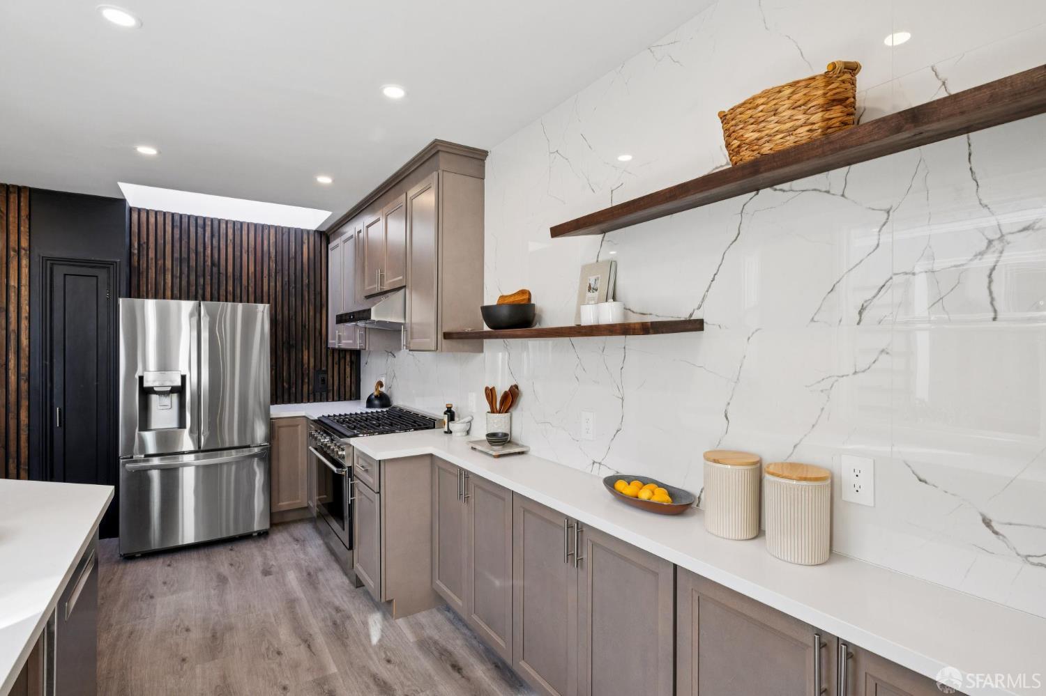 1675 29th Avenue San Francisco, CA 94122 - Photo 14 of 61 a kitchen with stainless steel appliances a refrigerator a sink and wooden cabinets