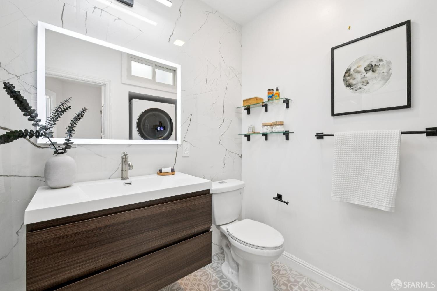 1675 29th Avenue San Francisco, CA 94122 - Photo 22 of 61 a bathroom with a toilet sink and mirror
