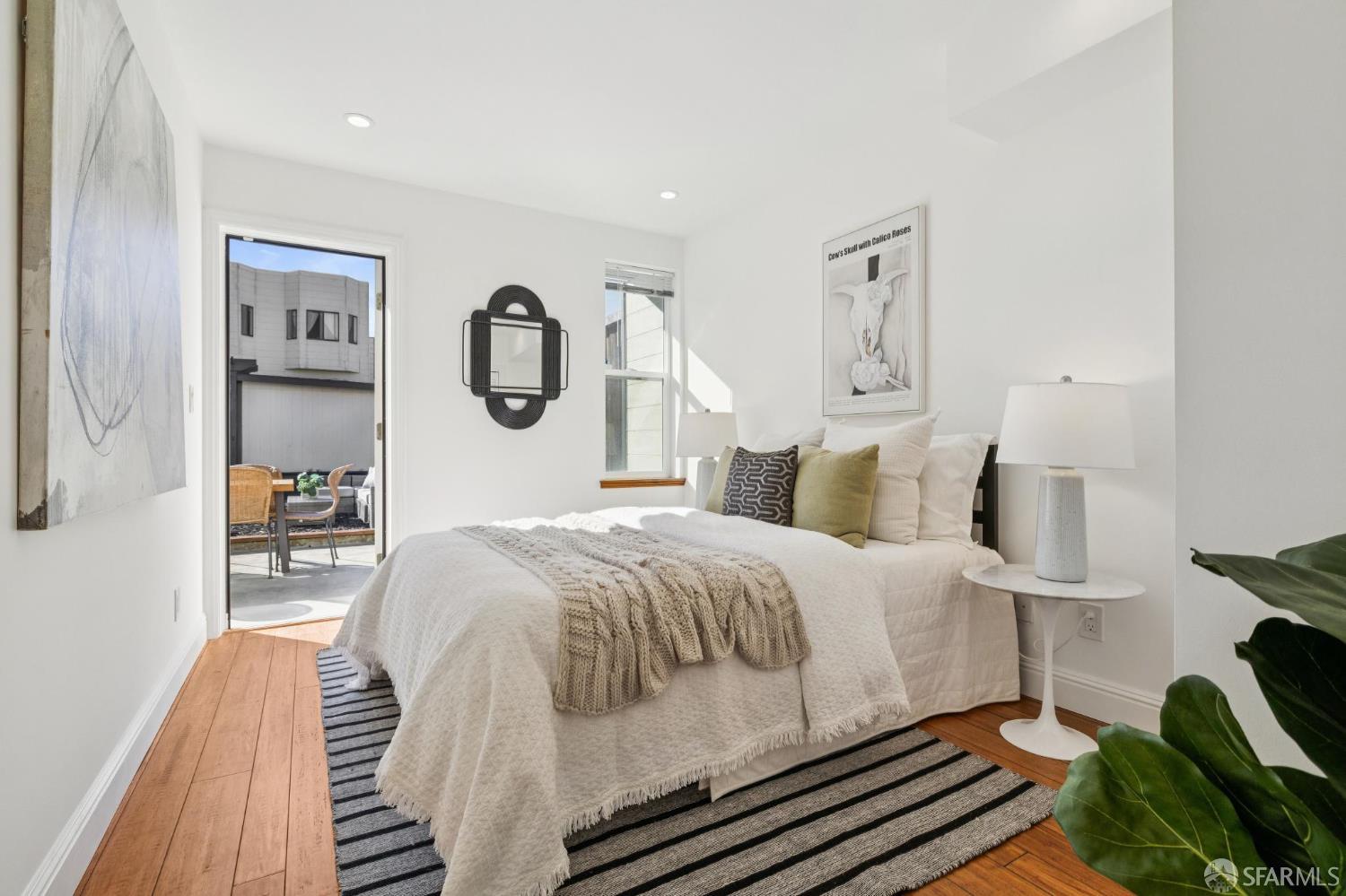 1675 29th Avenue San Francisco, CA 94122 - Photo 45 of 61 a bedroom with a bed and wooden floor