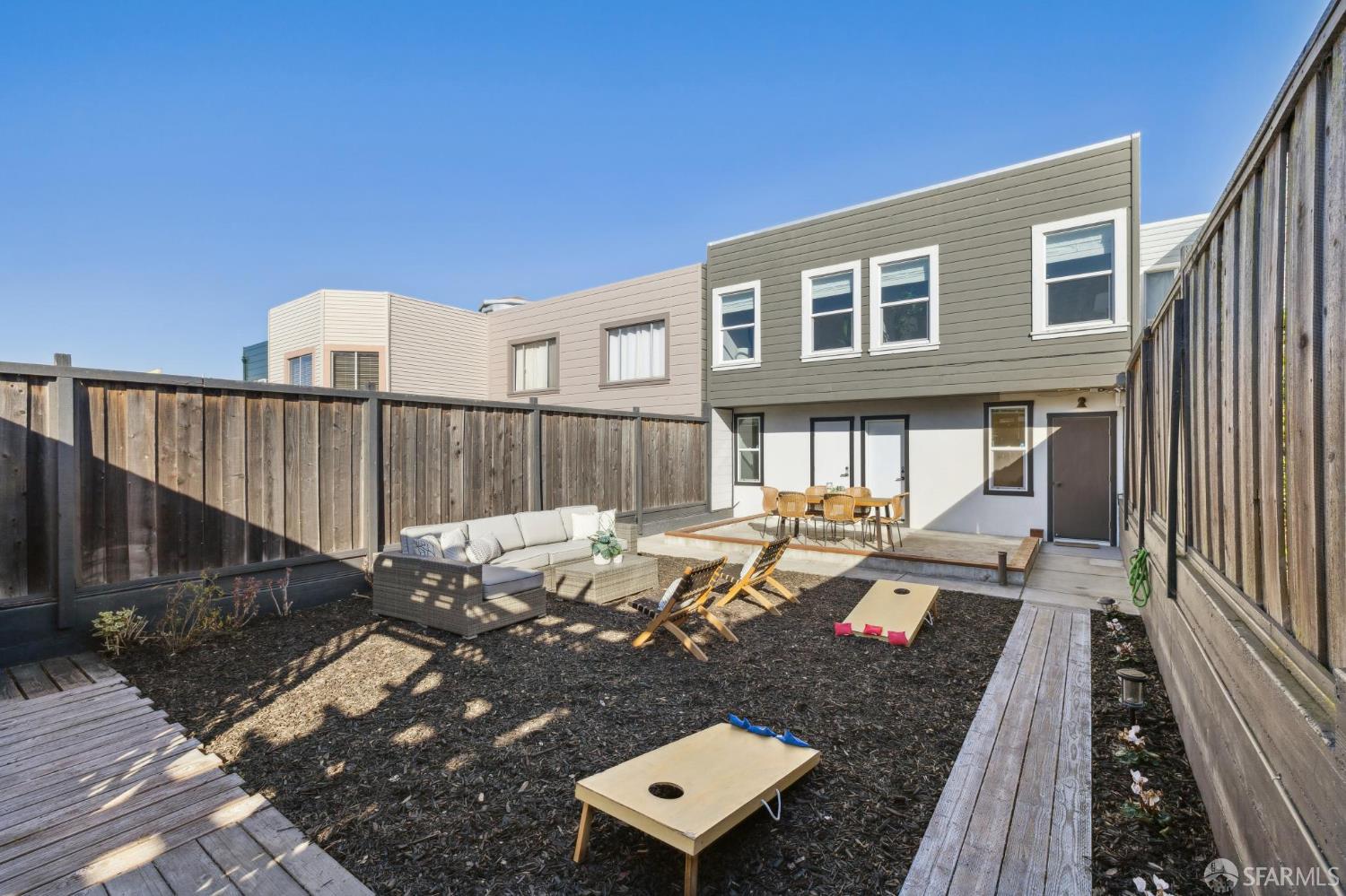 1675 29th Avenue San Francisco, CA 94122 - Photo 53 of 61 a view of a patio with couches table and chairs with wooden floor and fence