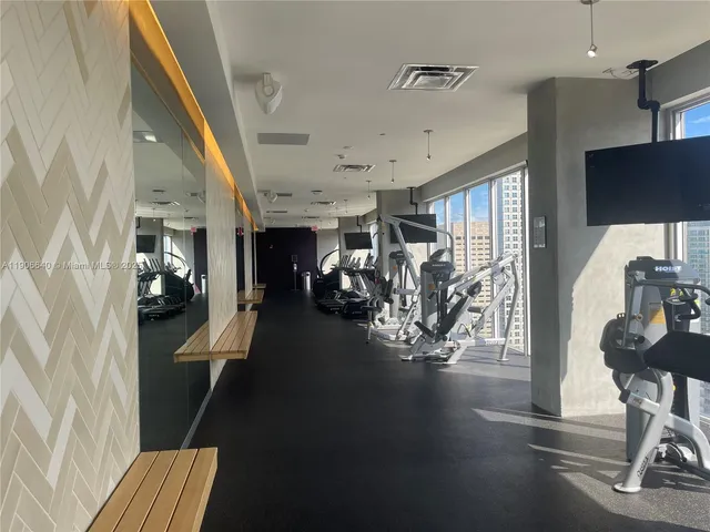 a room with pool table and windows