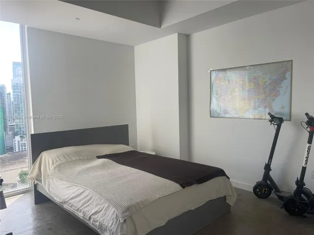 a bedroom with a bed and a chair