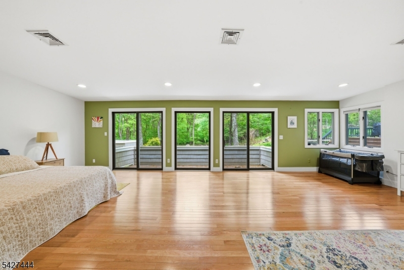 156 Kingsland Road Boonton, NJ 07005 - Photo 18 of 38 a spacious bedroom with a balcony a large bed and a large window