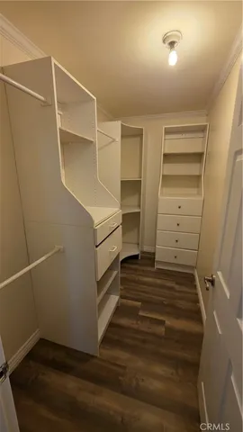 a view of walk in closet with empty racks