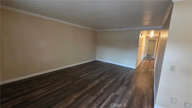 a view of room with wooden floor and fan