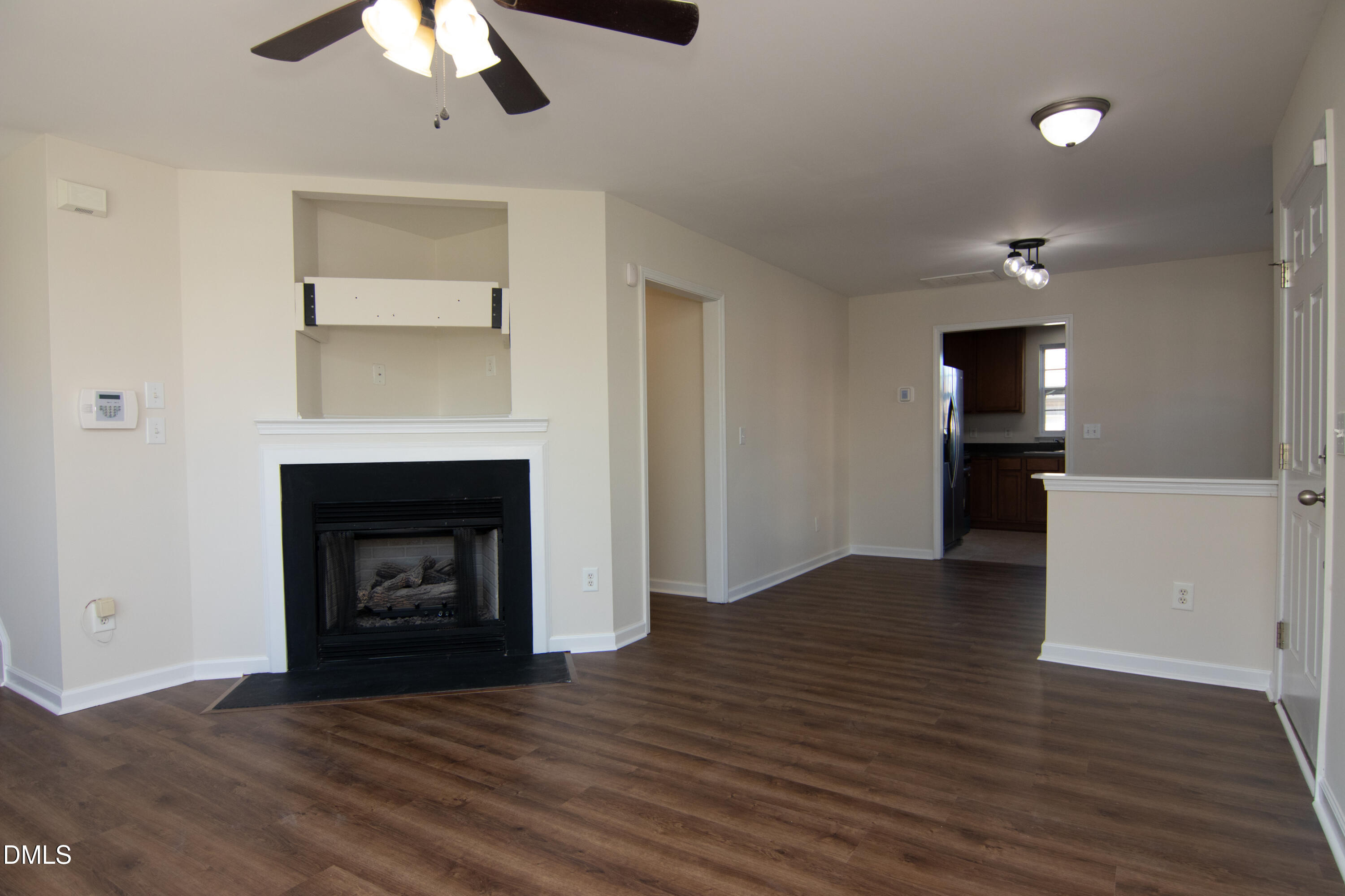 9903 Grettle Court Raleigh, NC 27617 - Photo 10 of 40 a view of empty room with wooden floor and fireplace