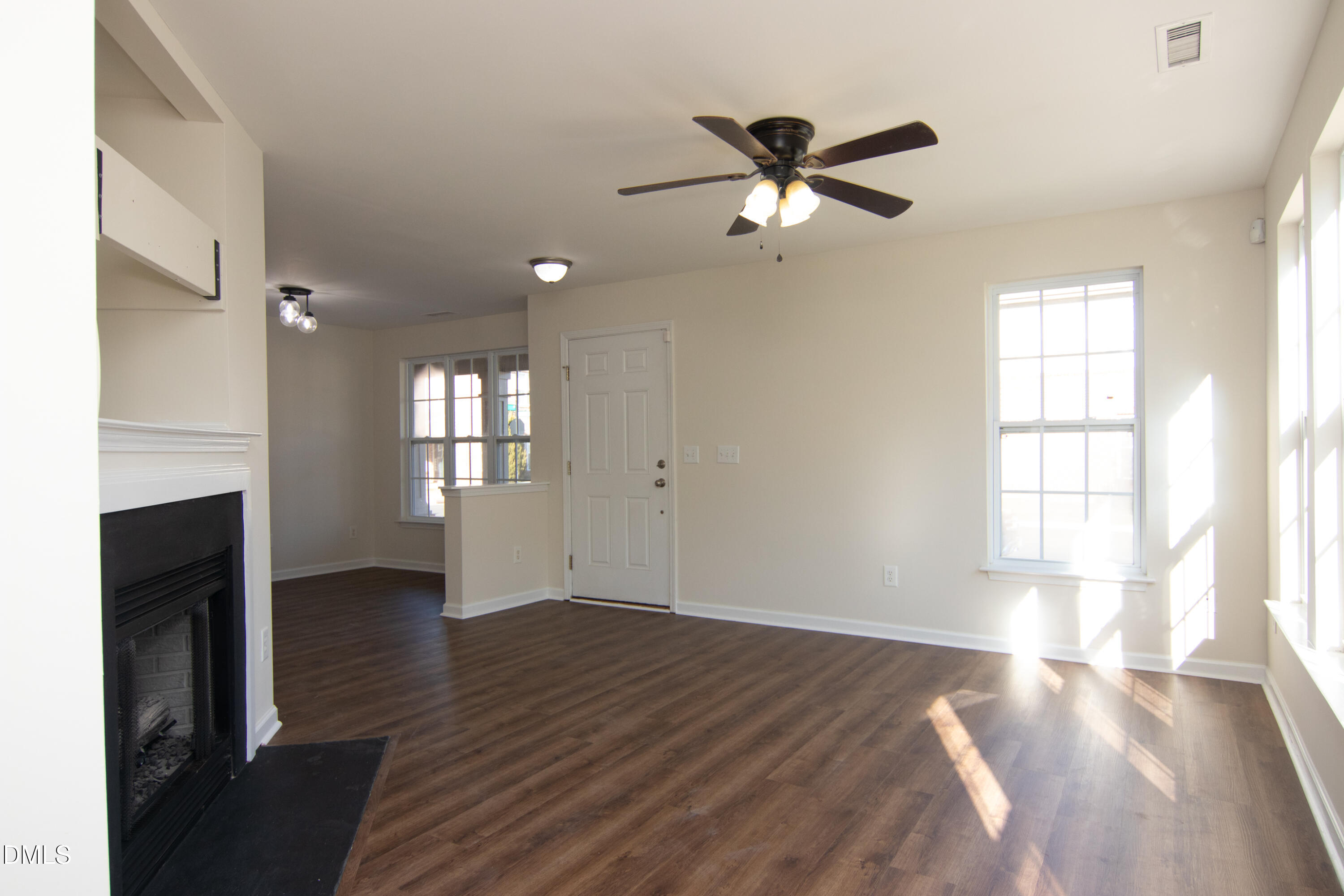 9903 Grettle Court Raleigh, NC 27617 - Photo 12 of 40 a view of empty room with wooden floor and fan